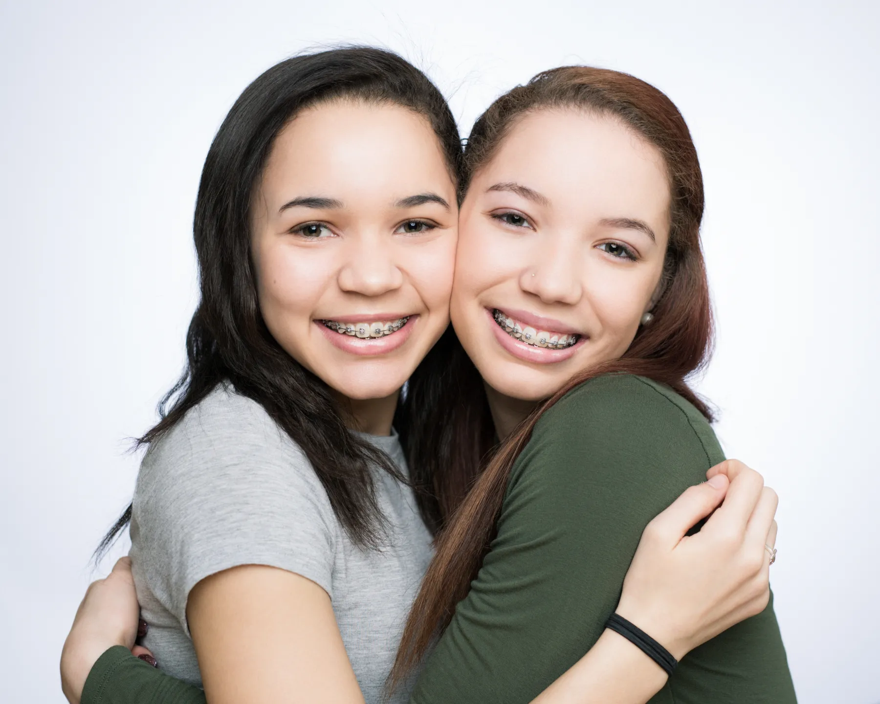 Two smiling teen patients wearing Damon self-ligating braces