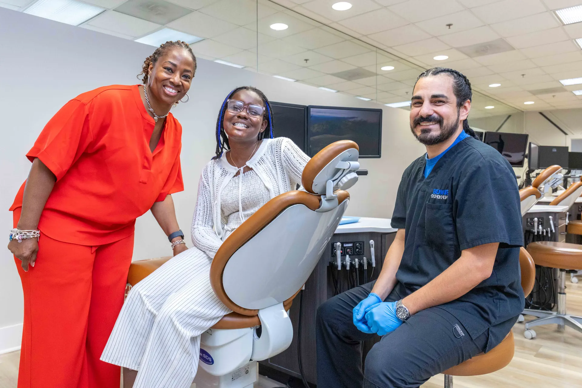 A Bowie Braces care team member and clinician with a patient in the treatment bay