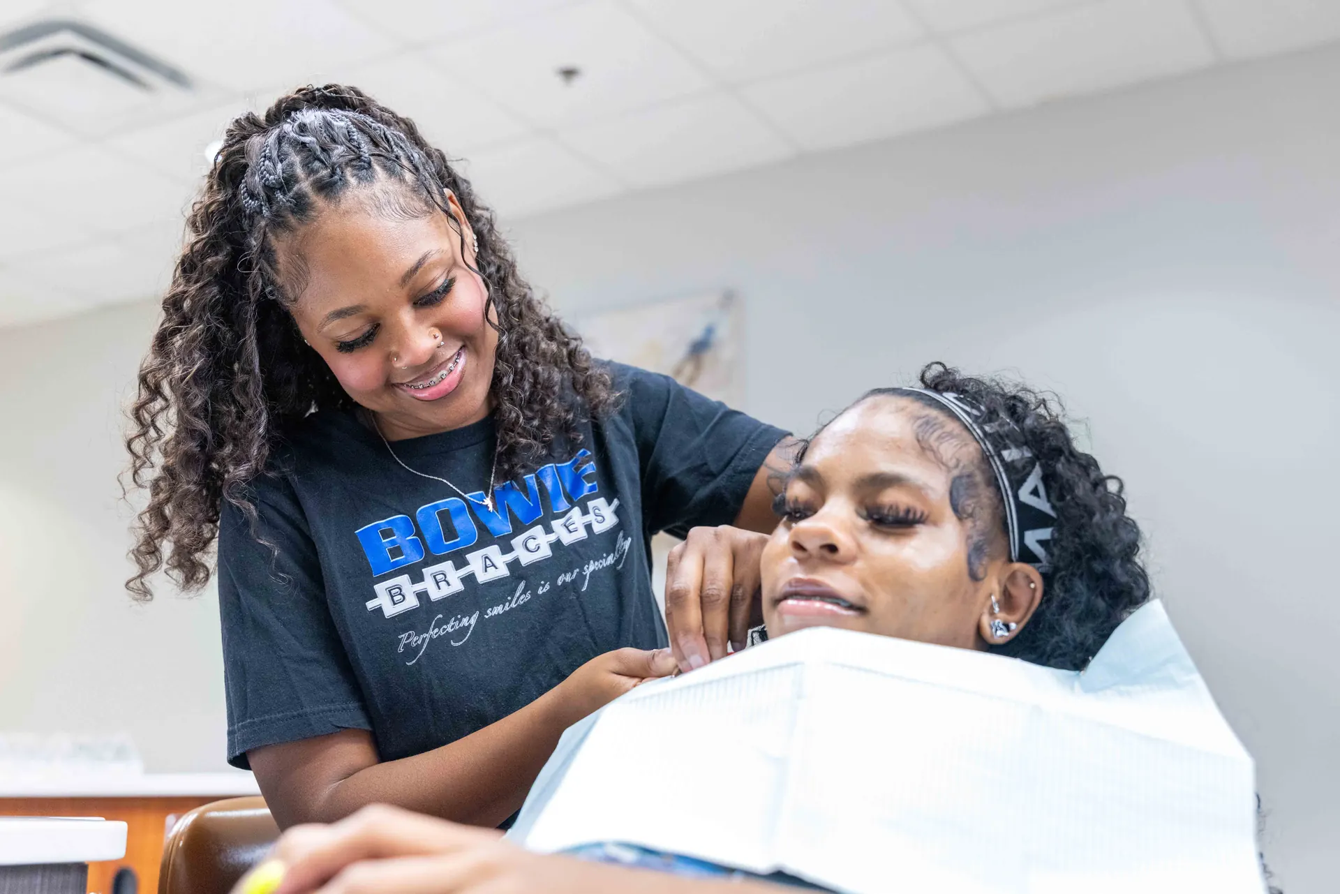 A Bowie Braces team member caring for a patient chairside