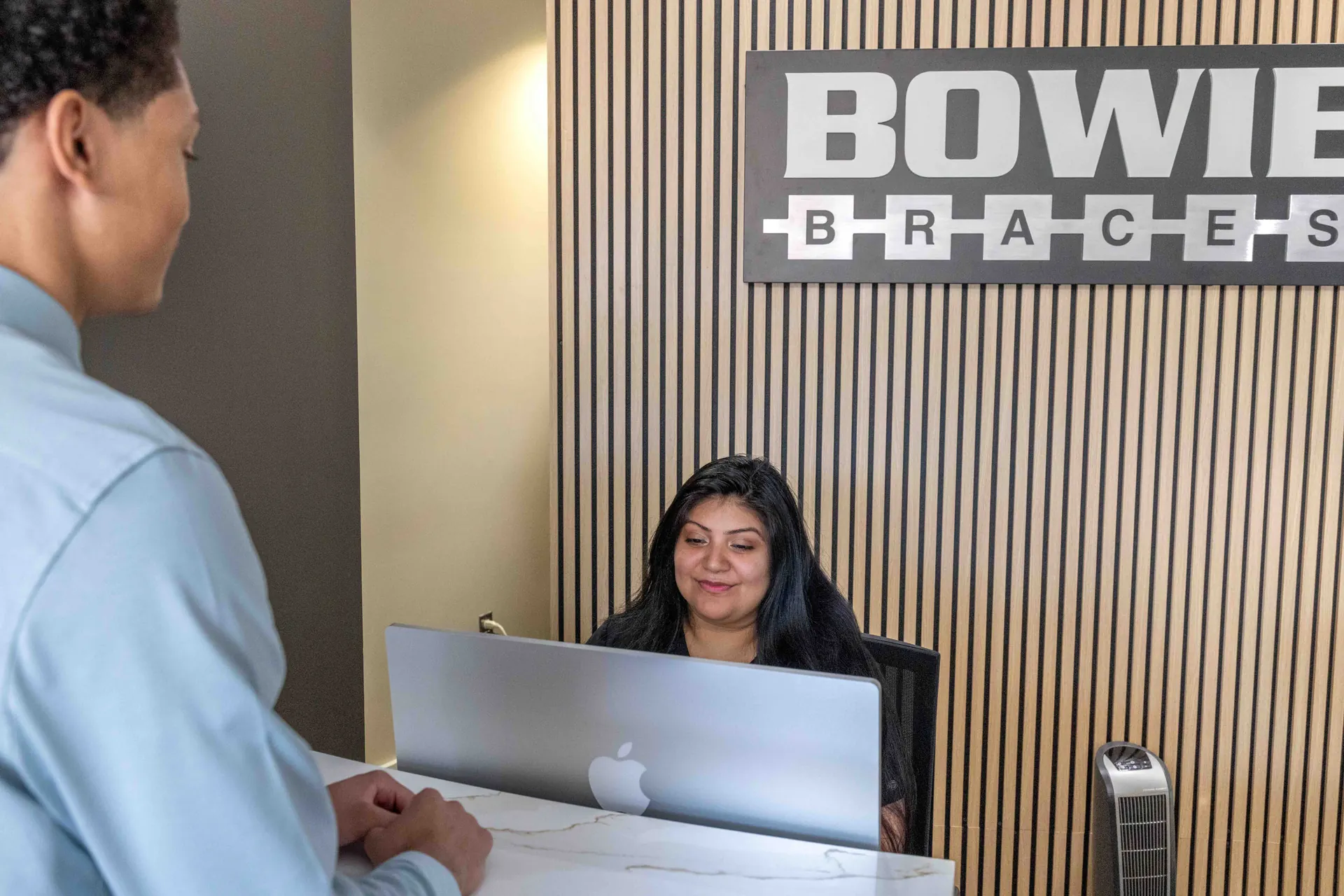 A patient checking in at the Bowie Braces front desk