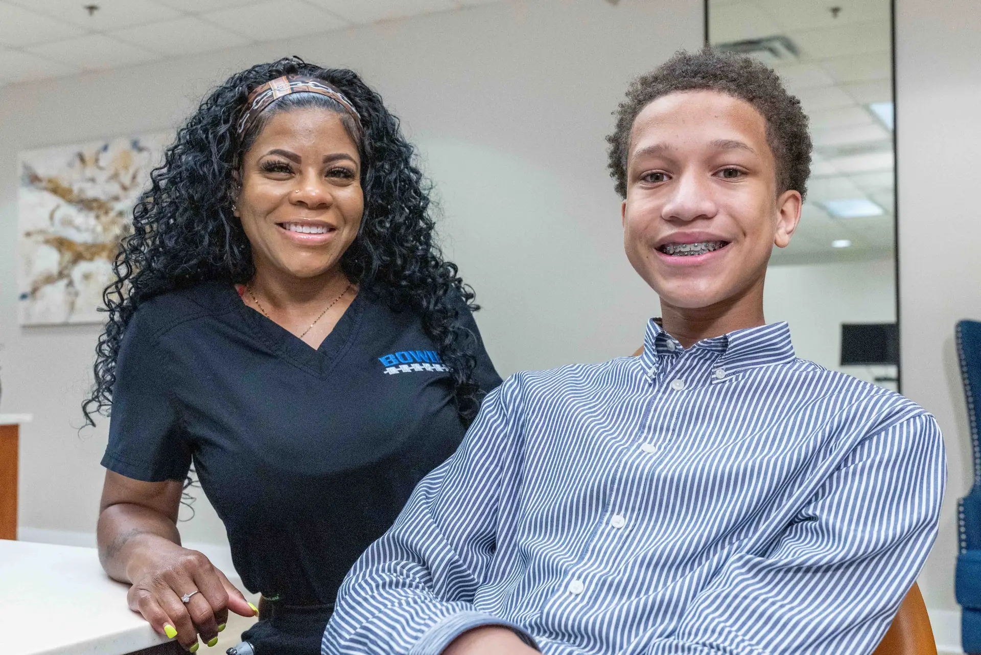 A Bowie Braces team member with a teen patient wearing braces