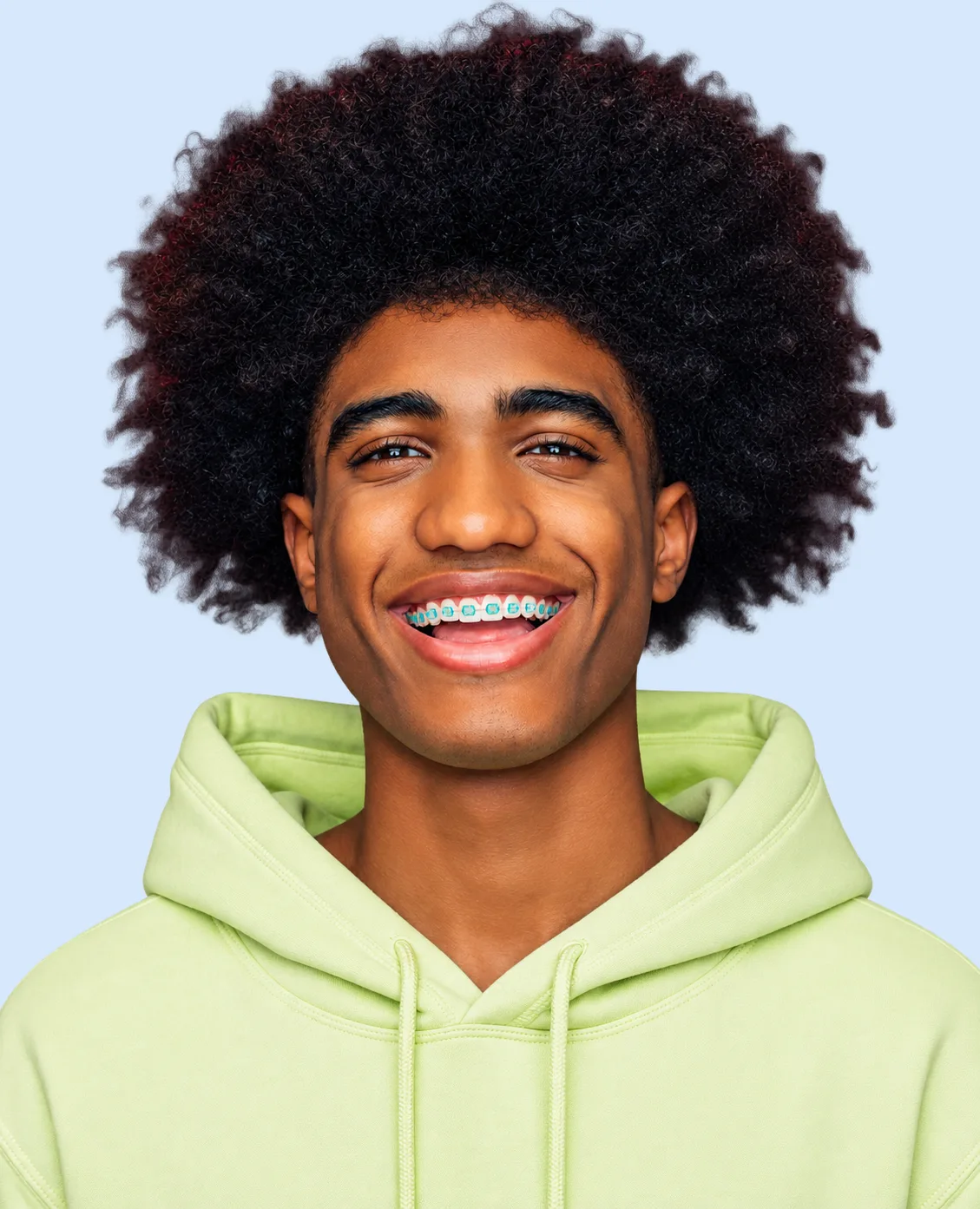 Smiling teen wearing tooth-colored ceramic braces